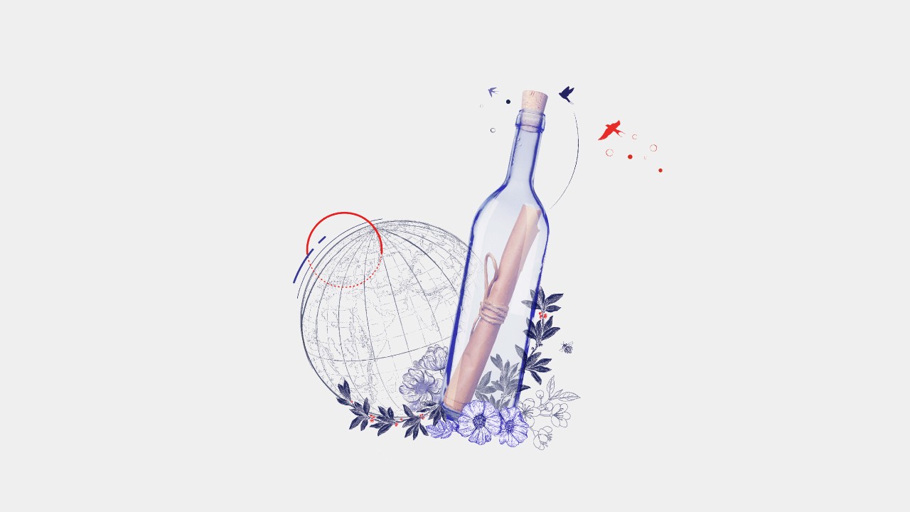 Paper scroll in a glass bottle, with illustrations of flowers and the globe.
