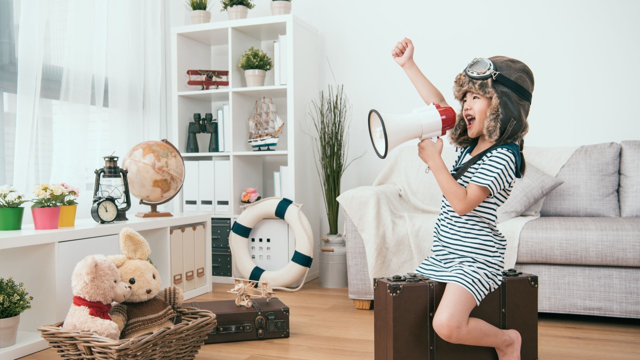 A girl role playing as pilot at home; image used for HSBC Taiwan Co-Brand Card conversion page.