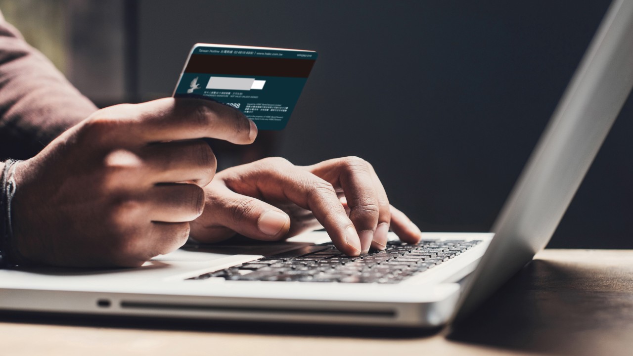 A man inputting card information into laptop; image used for HSBC Taiwan Co-Brand Card conversion page.