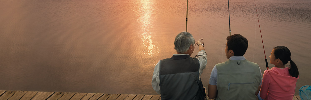 Three people are fishing by the lake; image used for Premier Mortgage.